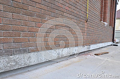 New construction waterproofing basement walls from outside. Stock Photo