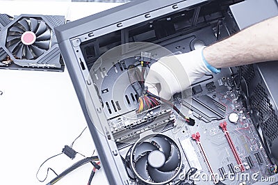 Hands of a technician assembling computer hardware parts new cpu is being mounted unto the motherboard Stock Photo