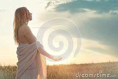 A new day begins with the sunrise protected in the hands of a woman Stock Photo