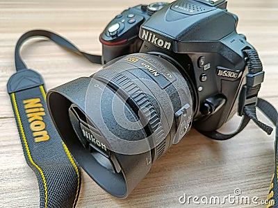 New Delhi, India, May 28 2023 - Nikon D5300 camera with 35mm f2.8 prime lens on plain background, Nikon DSLR camera shoot Editorial Stock Photo