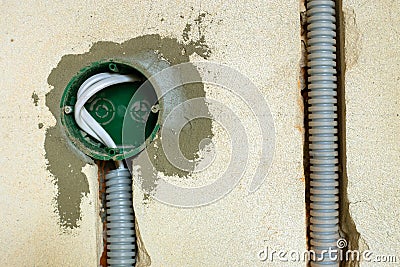 New electrical wiring installation, plastic boxe and electrical cable for future outlet sockets on the wall, renovation concept Stock Photo