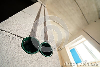 New electrical wiring installation, plastic boxes for electrical cables for future outlet sockets on the wall, renovation concept Stock Photo