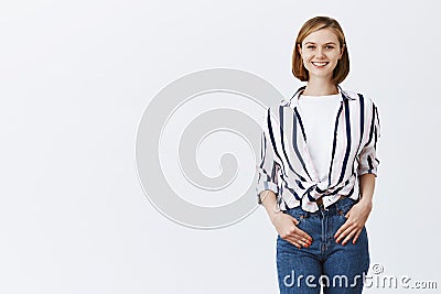 New employee starting working in office, smiling while meeting coworkers. Charming happy young woman in trendy outfit Stock Photo