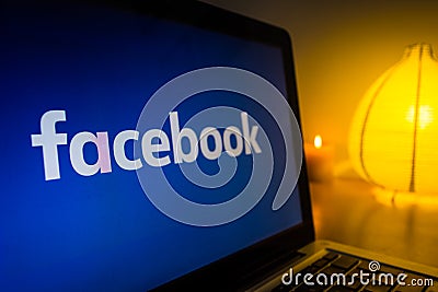 New facebook logo on a computer screen, turned on the light in the background Editorial Stock Photo