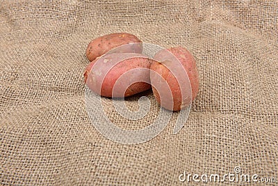 New fresh red potatoes jute background. Concept of healthy food, bio from countryside Stock Photo