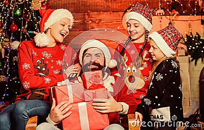 new Gift. santa father at decorated tree. Happy family celebrate new year and Christmas. small girls sisters with Stock Photo