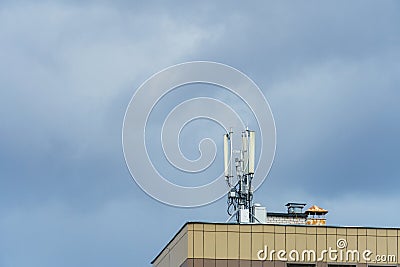 New GSM antennas on the roof of a residential building in the city for transmitting a 5g signal are a danger to human health. Stock Photo