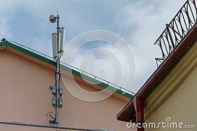 New GSM antennas on the roof of a residential building in the city for transmitting a 5g signal are a danger to human health. Stock Photo