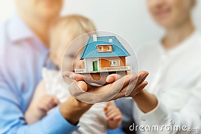 New home concept - young family with dream house scale model Stock Photo