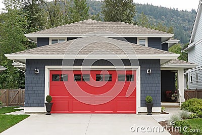 New Home House Exterior Blue with a Bright Red Garage Door Elevation Stock Photo