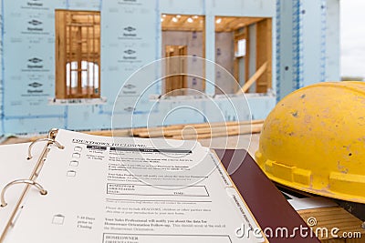 A new house under construction and new home closing documents folder Editorial Stock Photo