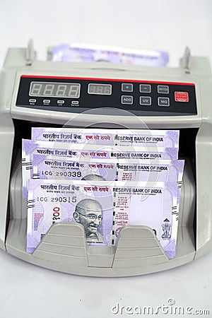 New Indian currency notes in the cash counting machine Editorial Stock Photo