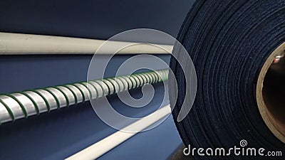 New industrial dark blue roll, dark blue background. Concept: material, fabric, manufacture, garment factory, new samples of fabri Stock Photo