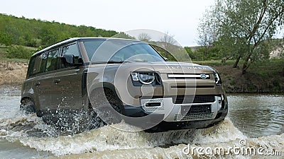 Land Rover Defender 2020 Moving across the river. Elegant and brutal Britain SUV Editorial Stock Photo