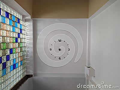 new and large dial clock built into the wall. Stock Photo