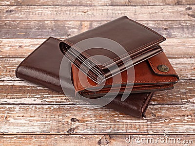 New leather multicolored wallets on wooden background Stock Photo