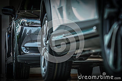 New luxury black shiny SUV compact car parked in modern showroom. Car dealership office. Car retail shop. Electric car technology Stock Photo