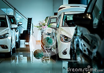 New luxury shiny compact car parked in modern showroom. Car dealership office. Car retail shop. Electric car technology Stock Photo