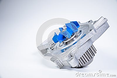 New metal automobile pump for cooling the engine of a water pump on a gray background. The concept of new spare parts Stock Photo