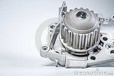 New metal automobile pump for cooling the engine of a water pump on a gray background. The concept of new spare parts Stock Photo