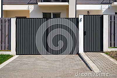 New metal gates and a fence in front of the house Stock Photo