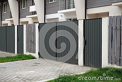 New metal gates and a fence in front of the house Stock Photo