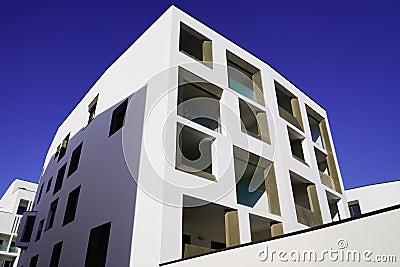 New modern buildings with white facade corner and blue sky in real houses on line for office and apartment Stock Photo
