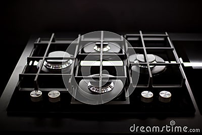 New modern gas stove with four burners for the kitchen, stainless steel surface. Cast iron grates. top view, close up Stock Photo