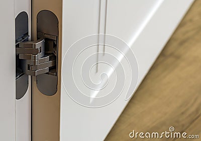 New modern metal door hinges on white wooden doors Stock Photo