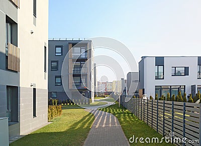 The new modern standard European modular homes with low cost apartments for young families and wooden gray fence Stock Photo