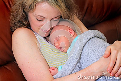 New Mom Cuddles Newborn Baby Stock Photo