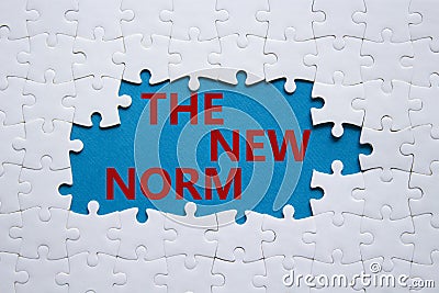 The new norm symbol. Concept words The new norm on white puzzle. Beautiful blue background. Business and The new norm concept. Stock Photo