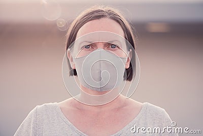 New normal, portrait of casual adult female person with protective face mask Stock Photo