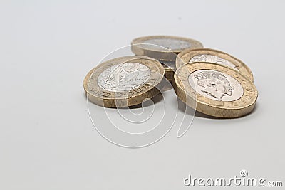 New one pound sterling coins isolated in white background, British currency monies Editorial Stock Photo