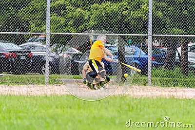 Softball Batter Swinging at Pitch and Missing Editorial Stock Photo