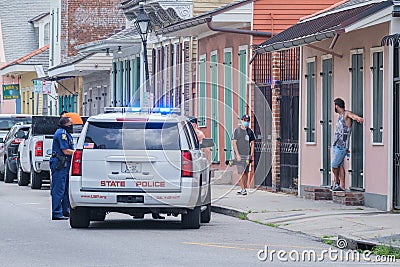 State Police car pulled over in French Quarter with onlookers Editorial Stock Photo