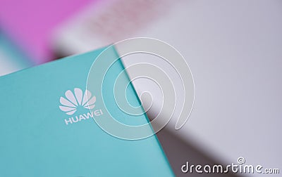 New package box huawei smartphone with white HUAWEI logo on top blue background Editorial Stock Photo