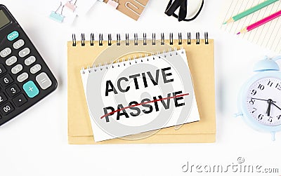 New PASSIVE - ACTIVE text written on a notebook Stock Photo