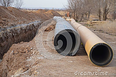 The new propylene pipeline DN 350 and DN 500 prepared for laying in a trench and for pumping oil and gas for an oil refinery Stock Photo