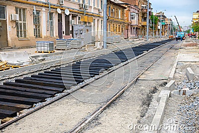 New rails and wooden sleepers are prepared for laying on gravel Stock Photo