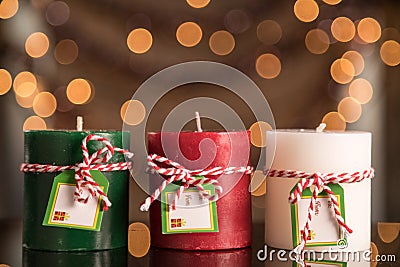 New Red, Green And White Pillar Candle Abstract Blurred Christmas Background. Selective Focus With Copy Space. Stock Photo