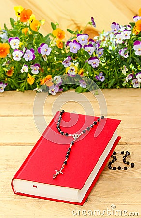 New red Holy Bible and black rosary Stock Photo