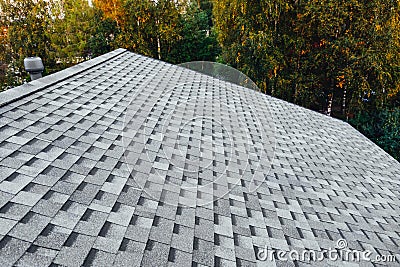 New renovated roof with shingles flat polymeric roof-tiles Stock Photo