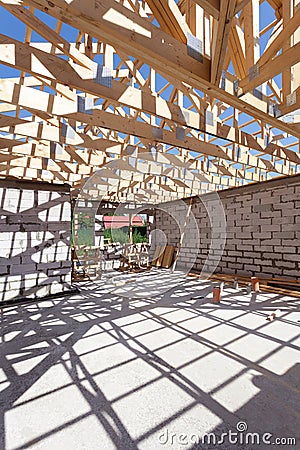 New residential wooden construction home framing. Building a roof with wooden balks. Stock Photo
