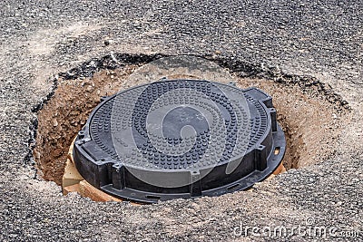 New round Iron manhole cover on the road Stock Photo