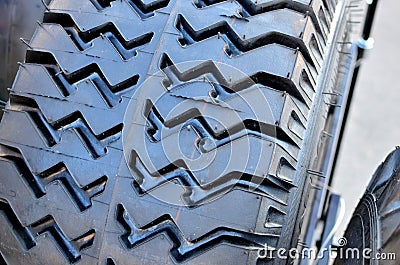 New rubber tire with tread for trucks and special construction wheeled vehicles for driving on asphalt roads and off-road Stock Photo