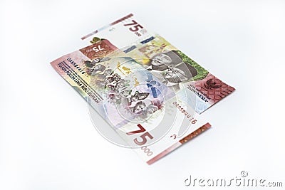 75,000 new rupiah on top of another pile of rupiah bills Stock Photo