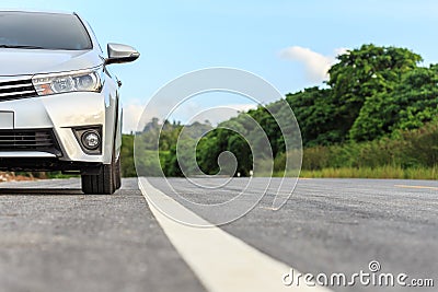 New silver car parking on the asphalt road Stock Photo