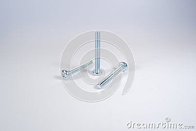 New small long screws on gray white background Stock Photo