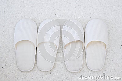 New softness white slippers on marble floor background at luxury hotel or modern home. Relax and travel concept Stock Photo